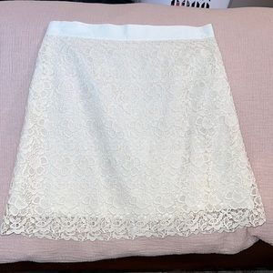 textured skirt in ivory with liken like lining.  Hits just at/above knee.